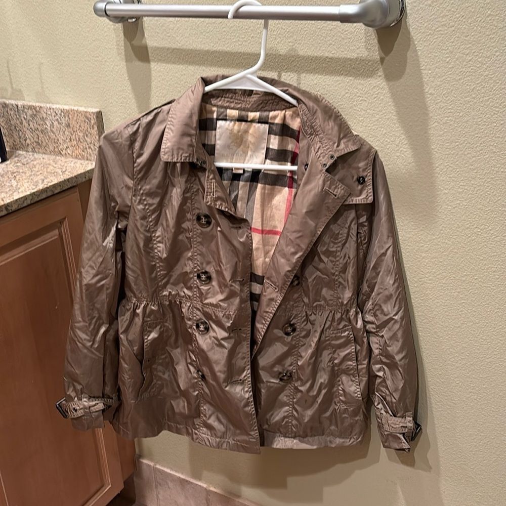 Burberry kids nylon trench coat. It's a size 12 years old trench coat